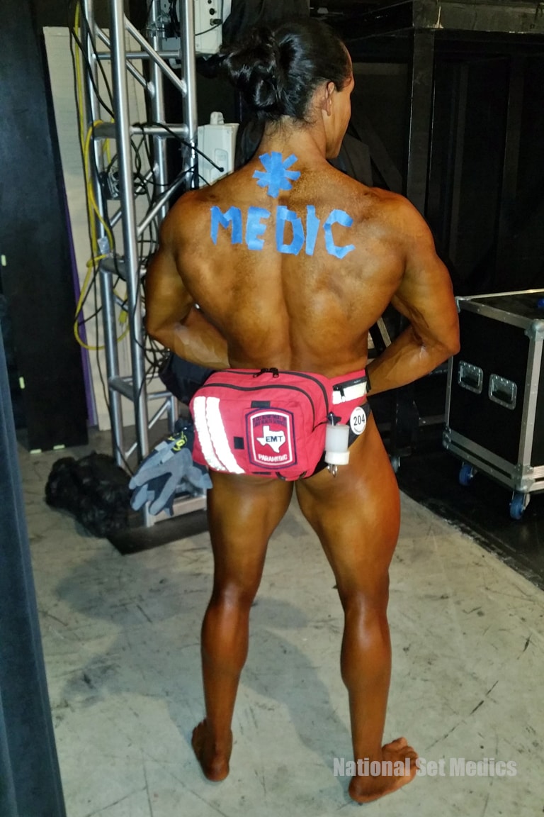 NSM medic with EMT fanny pack at a bodybuilding competition backstage