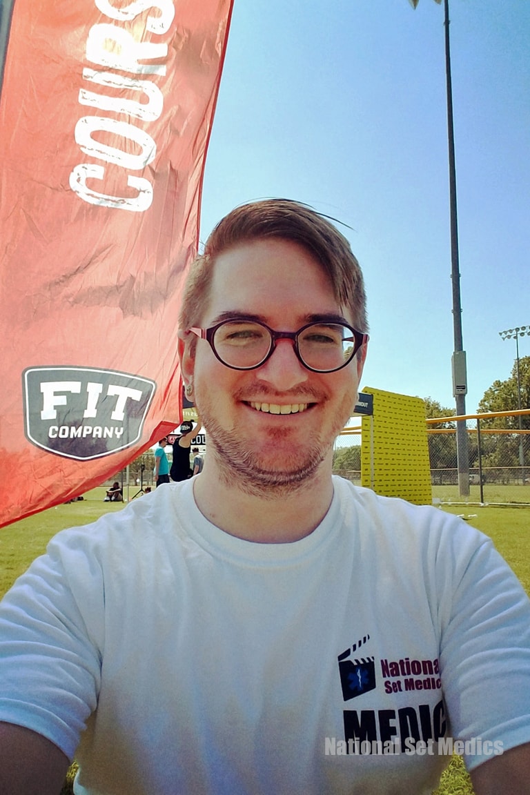 NSM medic smiling at a Fit Company outdoor fitness event