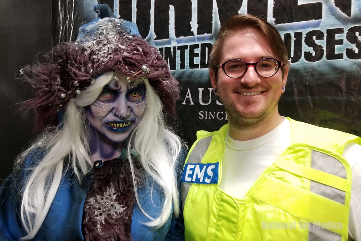 NSM EMS medic posing with a costumed haunted house character