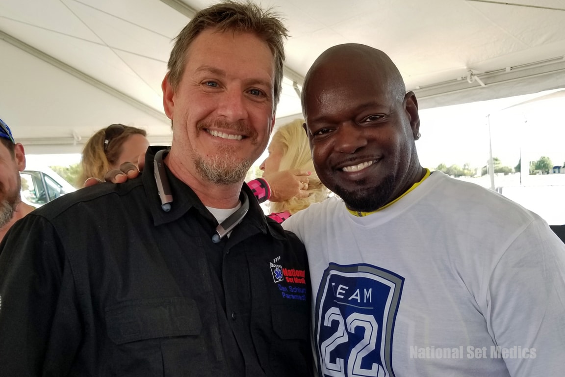 NSM paramedic smiling with a guest at an outdoor event