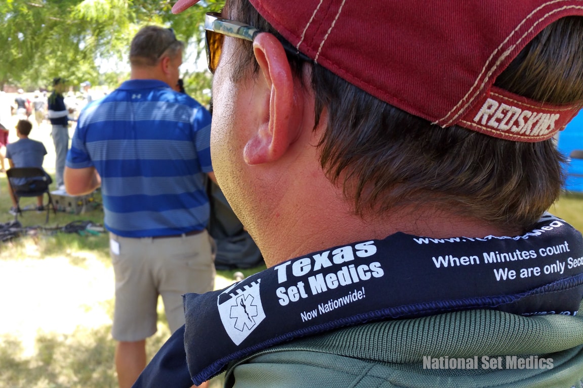 Texas Set Medics branded lanyard worn by a medic at an outdoor event